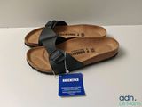 new birkett black sandals with a tag on the bottom