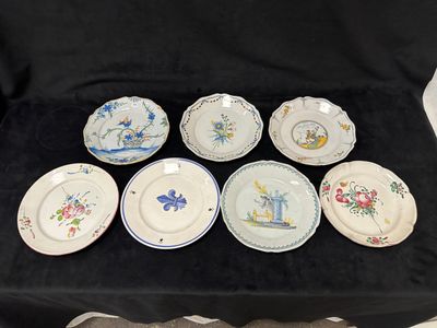 six assiettes ornées de motifs différents, posées sur une nappe noire