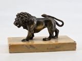 an image of a bronze statue of a lion on a marble base