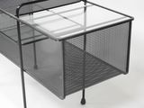 a black mesh desk with a glass top and metal legs