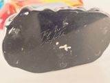a black object with writing on it sitting on a table