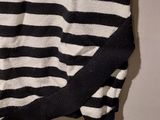 a black and white striped shirt hanging on a hanger