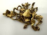 brass lion head broochle on a white background