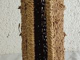 a brown vase with a black stripe on it