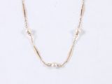 a close up of a necklace with pearls on a white background