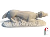 a statue of a dog laying down on a pillow