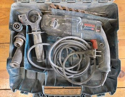a tool case with tools in it on a wooden floor
