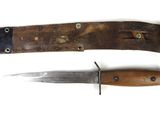 pair of knives with leather sheaths on a white surface