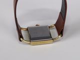 an image of a watch with a brown leather band on a white surface