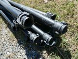 four black pipes laying on the ground next to each other