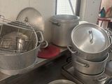 several pots and pans are sitting on a counter in a kitchen