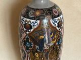a blue and gold vase sitting on a table