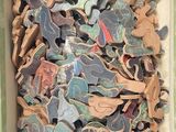 a box full of pieces of wood that are in the shape of animals
