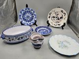 a lot of blue and white plates and bowls on the table