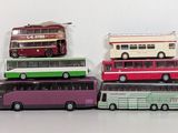a lot of toy buses sitting on top of each other