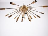 a gold chandelier hanging from a ceiling in a room