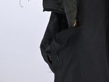 someone is wearing a black jacket with a hood over their head