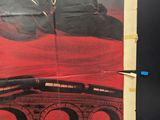 a poster of a man riding a motorcycle on a bridge