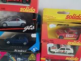 a lot of toy cars that are sitting on a table