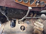 an old car dashboard with a bunch of gauges on it
