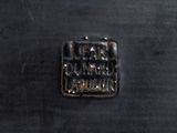 an image of a close up of a metal object on a black surface