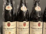 four bottles of wine are wrapped in plastic on a table