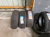 four tires are lined up next to each other in a garage