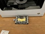 a piece of paper on the table next to a printer