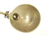 a silver bowl with a metal handle on a white surface
