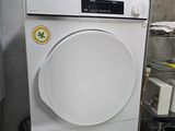 an image of a white washing machine in a room