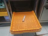 a yellow tray with a cigarette in it sitting in an oven