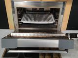 a machine that is sitting on the floor with a tray in it