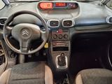 a dashboard of a small car with a clock on the dash