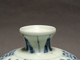 a blue and white vase sitting on a table
