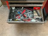 a tool drawer with tools in it in a garage