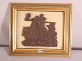 wooden carving of a man and woman on a boat in a frame