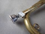 a brass trumpet that is sitting on a table
