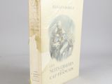 an old book sitting on top of a table next to a white wall