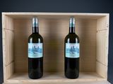 two bottles of wine in a wooden box on a table