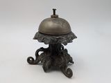 an image of a small bronze bell sitting on top of a table