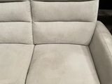 two reclining chairs in a room with a television on the wall
