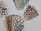 a lot of different foreign currency on the table