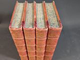 six old books stacked on top of each other on a table