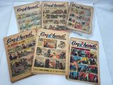 six old comic books are sitting on a white surface