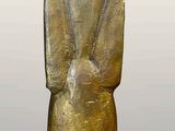 a gold statue of a woman ' s head on a gray background