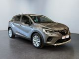 a grey renault c - hr suv parked in a showroom