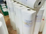 several rolls of paper are stacked on top of each other in a warehouse