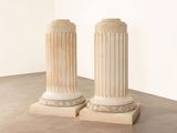 two white pillars in the middle of a room
