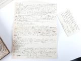 a piece of paper with writing on it next to a book