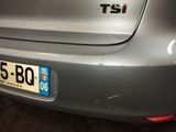 the rear end of a silver car with a number plate on it